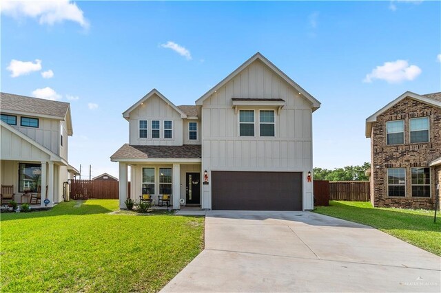 modern inspired farmhouse with fence, a front yard, board and batten siding, and driveway