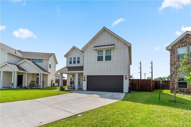 modern farmhouse style home with fence, concrete driveway, board and batten siding, a front yard, and a garage
