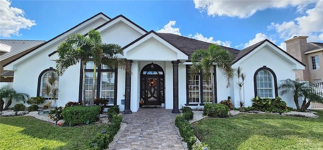 view of front of home with a front lawn and stucco siding