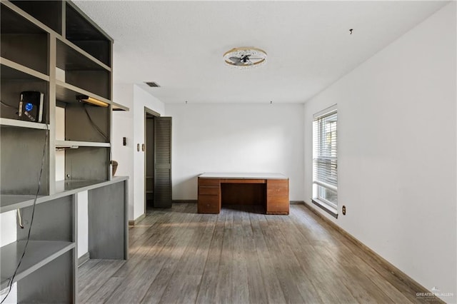 unfurnished office featuring hardwood / wood-style floors