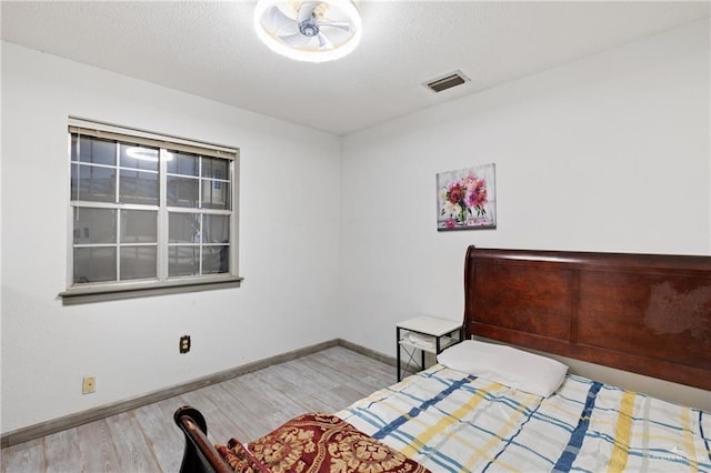 bedroom with light hardwood / wood-style floors