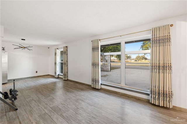 empty room with ceiling fan and hardwood / wood-style floors