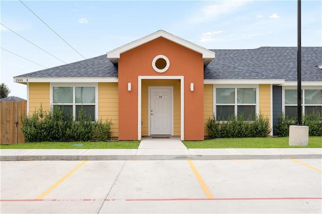 1500 Westgate Dr, Weslaco, TX 78596 - view of front of property featuring roof with shingles and uncovered parking