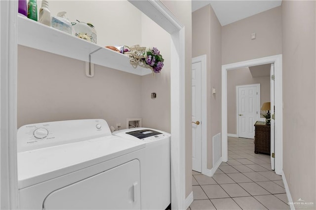 washroom with light tile patterned flooring and washing machine and clothes dryer