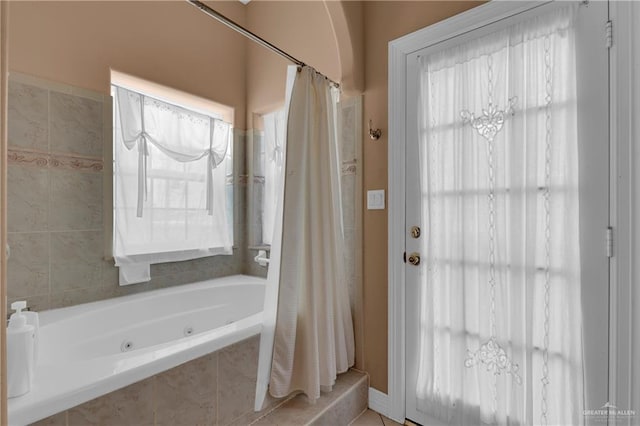 bathroom with tile patterned floors and shower / bath combo with shower curtain