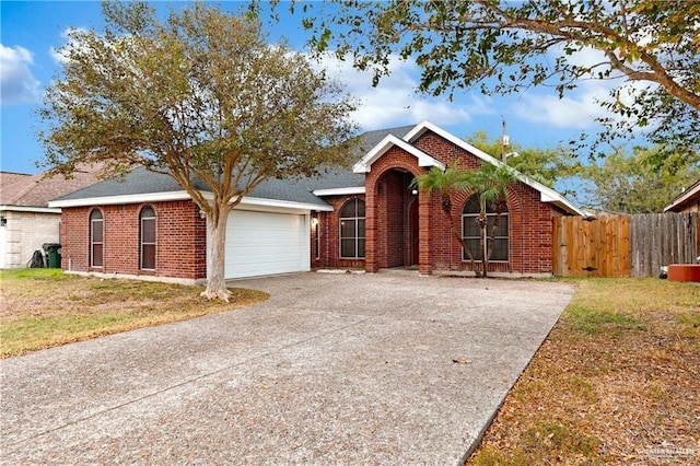 ranch-style home with concrete driveway, a garage, fence, and brick siding