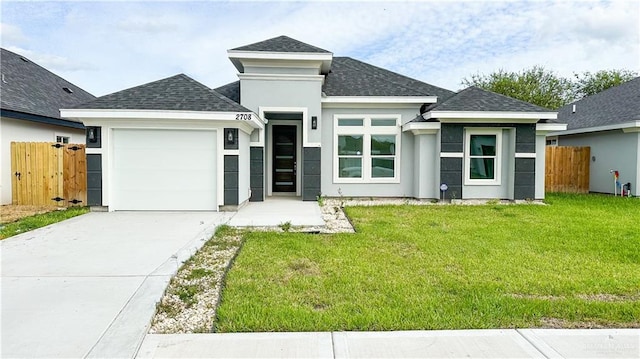 prairie-style home with a garage and a front lawn