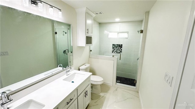 bathroom with a shower with door, vanity, and toilet