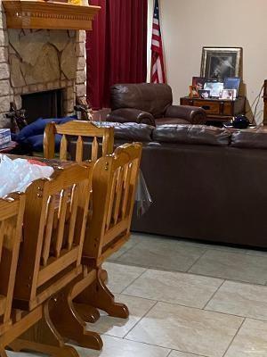 tiled living room with a fireplace