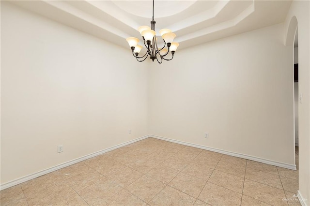 1502 N Popotillo Ave, Edinburg, TX 78541 - empty room with arched walkways, baseboards, a notable chandelier, and a tray ceiling