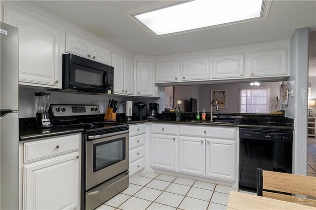 104 E Parade Dr Unit 12, South Padre Island, TX 78597 - kitchen featuring white cabinets, sink, and black appliances