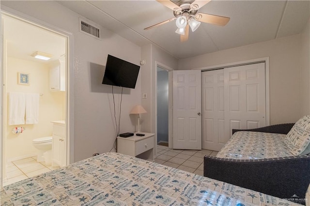 104 E Parade Dr Unit 12, South Padre Island, TX 78597 - bedroom with connected bathroom, ceiling fan, a closet, and light tile patterned floors