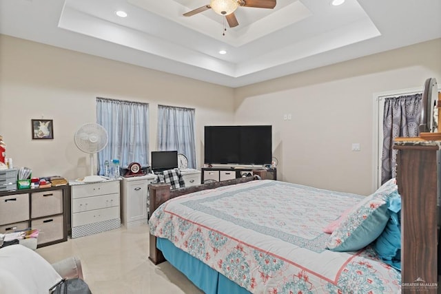 bedroom featuring a raised ceiling and ceiling fan