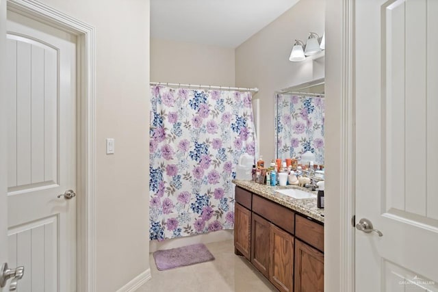 bathroom with a shower with curtain, vanity, and tile patterned floors