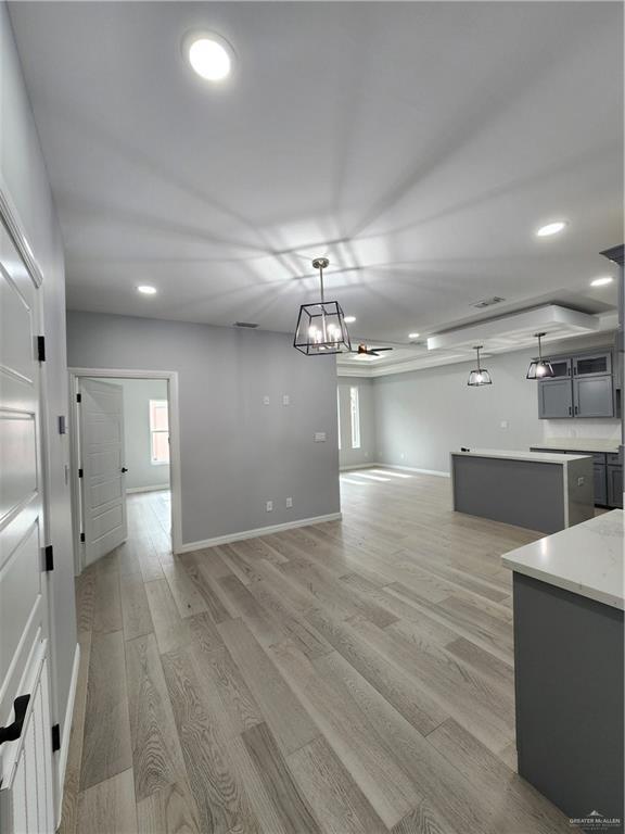 2838 Allen Dr, Edinburg, TX 78539 - kitchen with light wood-style floors, light countertops, baseboards, plenty of natural light, and recessed lighting
