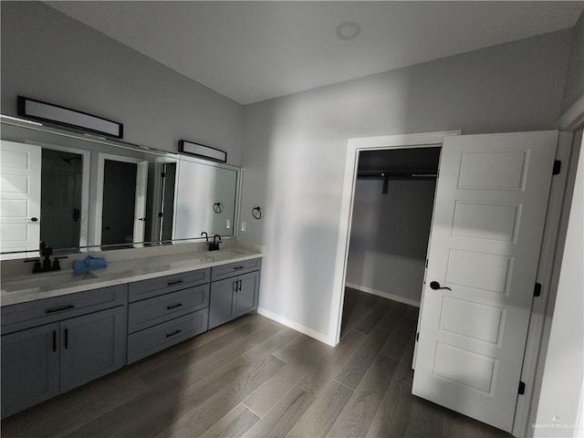 2838 Allen Dr, Edinburg, TX 78539 - full bath featuring double vanity, wood finished floors, a spacious closet, and baseboards