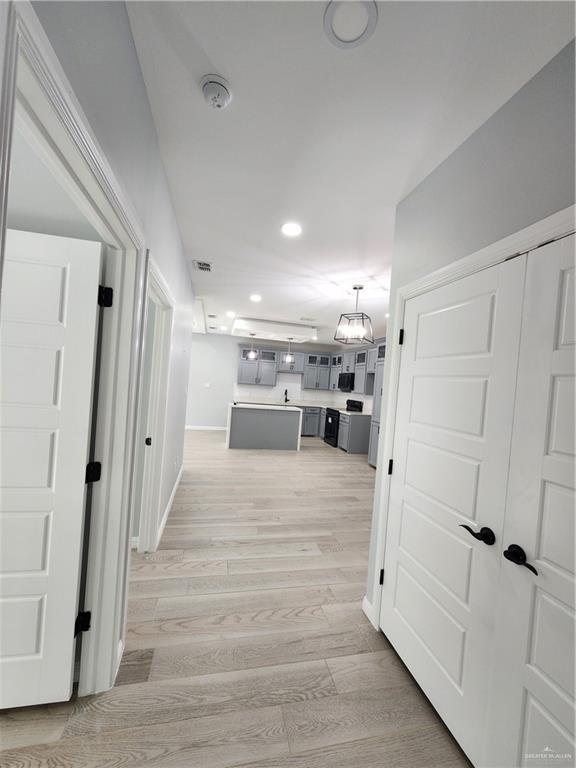 2838 Allen Dr, Edinburg, TX 78539 - corridor featuring light wood-style floors, recessed lighting, baseboards, and a chandelier