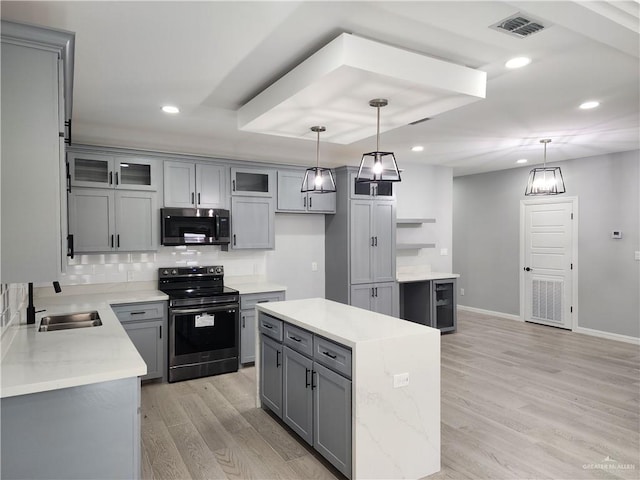 2838 Allen Dr, Edinburg, TX 78539 - kitchen with electric range oven, stainless steel microwave, gray cabinets, a sink, and light wood finished floors