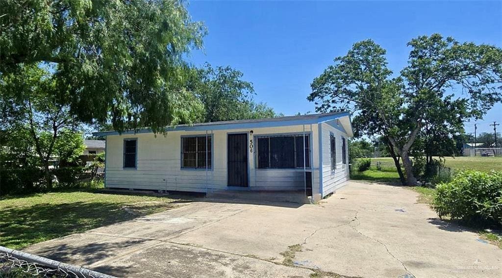 506 E Llano Grande St, Weslaco, TX 78596 - view of front facade with a front lawn and driveway