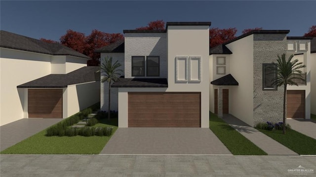 contemporary house with an attached garage, driveway, and stucco siding