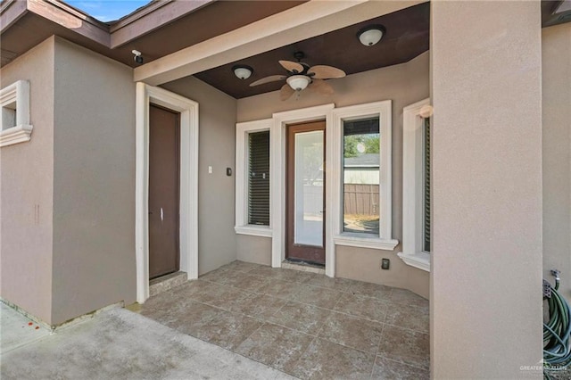 doorway to property with a patio and ceiling fan