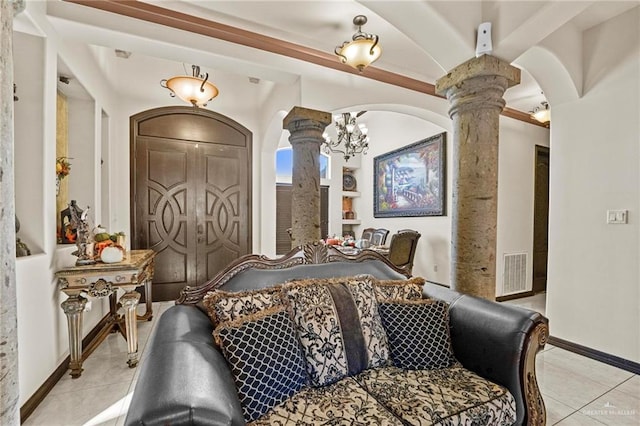 tiled bedroom with decorative columns and a notable chandelier