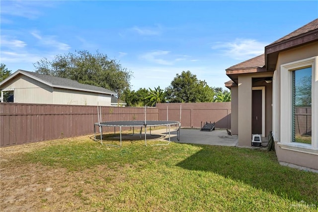 view of yard featuring a patio area and a trampoline