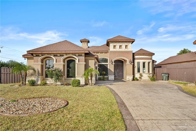 mediterranean / spanish home featuring a front yard