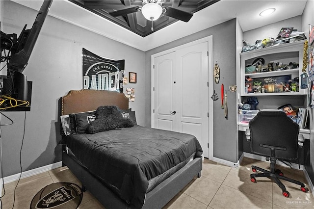 bedroom with light tile patterned floors, a closet, and ceiling fan