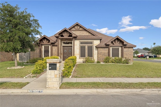 522 Camila St, Edinburg, TX 78542 - view of front of property featuring brick siding, a front lawn, and roof with shingles