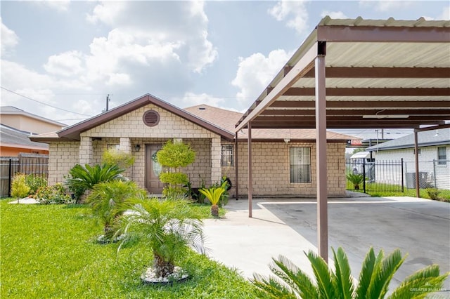 exterior space with a front lawn and a carport