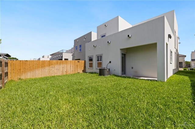 2312 Corales St, Mission, TX 78573 - rear view of property featuring stucco siding and central AC unit