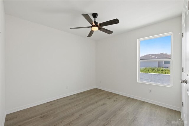 2312 Corales St, Mission, TX 78573 - empty room with light wood-style floors, baseboards, and a ceiling fan