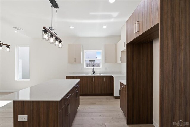 2312 Corales St, Mission, TX 78573 - kitchen featuring a sink, light countertops, a kitchen island, light wood-style flooring, and recessed lighting
