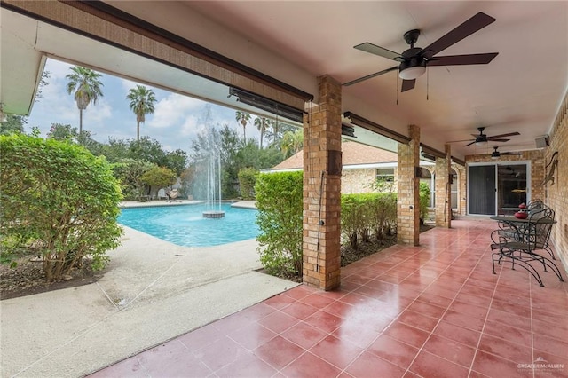 view of swimming pool with a patio and pool water feature