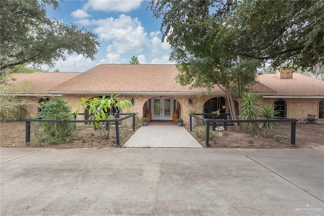 ranch-style house featuring french doors