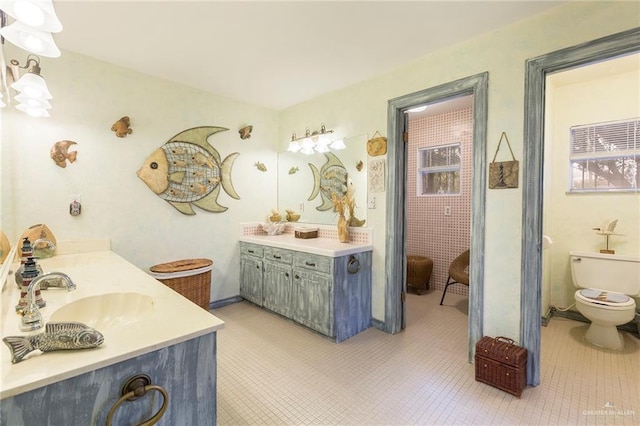 bathroom with vanity, tile patterned floors, and toilet