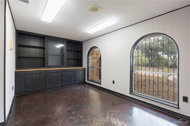 spare room featuring built in shelves