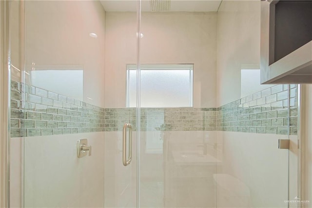 bathroom featuring a stall shower and visible vents