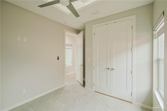 unfurnished bedroom featuring marble finish floor, multiple windows, visible vents, and baseboards