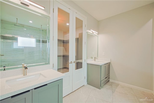 bathroom with marble finish floor, a marble finish shower, two vanities, and a sink