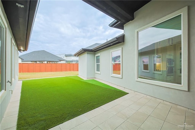 view of yard featuring fence and a patio