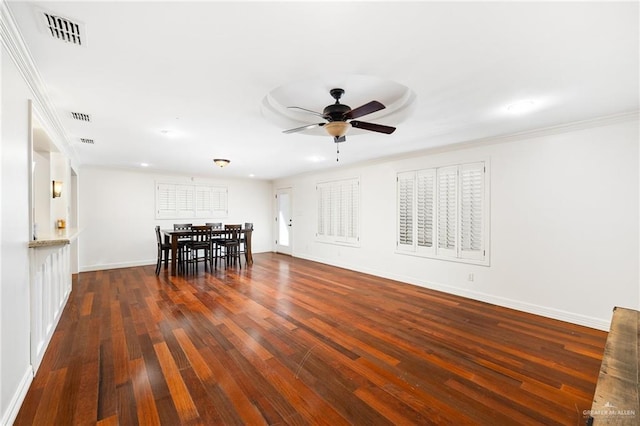 dining area featuring crown molding, dark wood finished floors, visible vents, and a ceiling fan