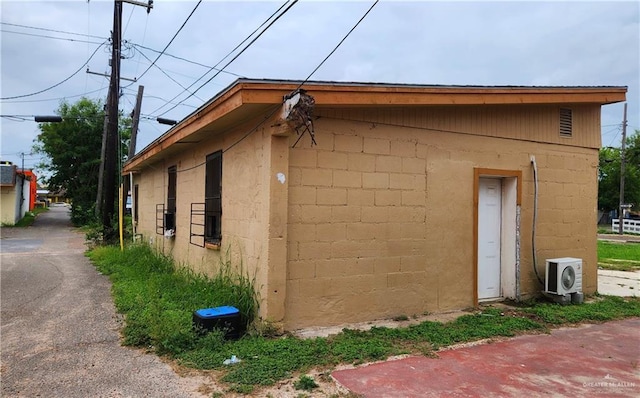 133 N Missouri Ave, Weslaco, TX 78596 - exterior space featuring concrete block siding and ac unit