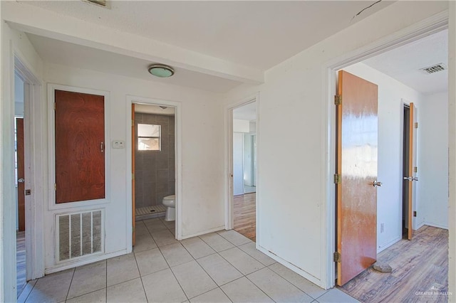 hallway with light tile patterned floors