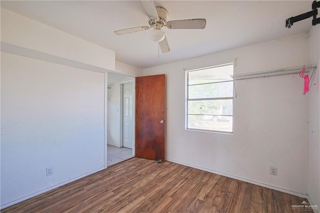 unfurnished bedroom featuring ceiling fan and light wood-type flooring