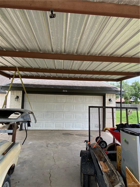 804 Ray St, Donna, TX 78537 - garage featuring fence and refrigerator