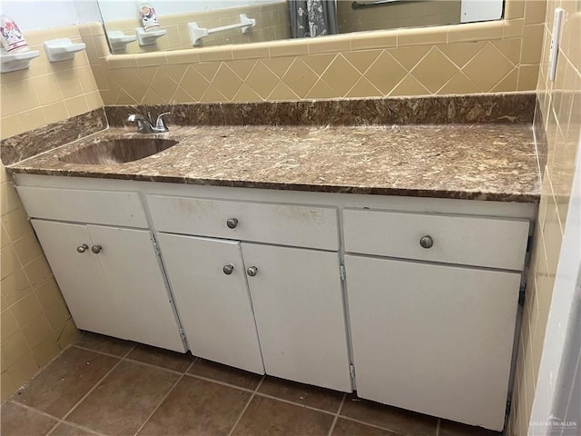 bathroom featuring backsplash, tile patterned floors, vanity, and tile walls