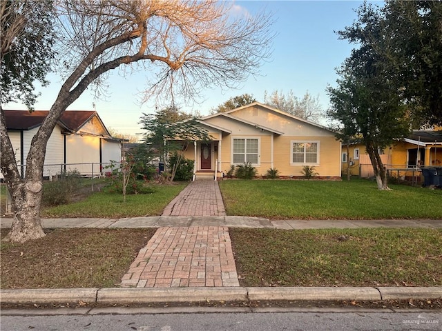 view of front of house featuring a lawn and a garage