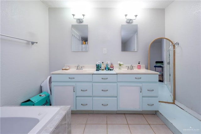 275 Violeta St, San Benito, TX 78586 - bathroom with double vanity, tiled bath, and tile patterned flooring